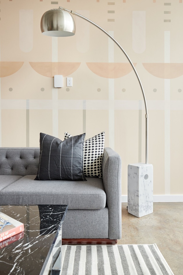 pink wallpaper and gray sofa